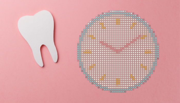 Illustration of a clock and a tooth on pink background