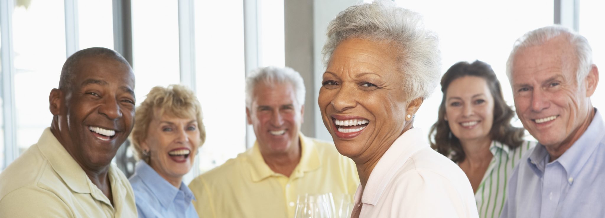 Elderly racially diverse group of permanent dental implant patients smiling