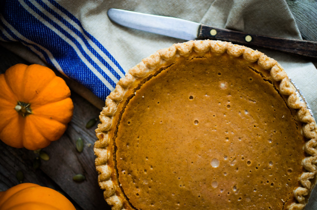 Pumpkin pie on rustic background